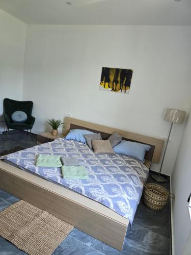 a bedroom with a bed with a blue comforter at Apartmani Korana in Karlovac