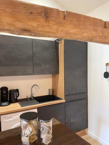a kitchen with a sink and a counter top at Le Croco in Montbrison
