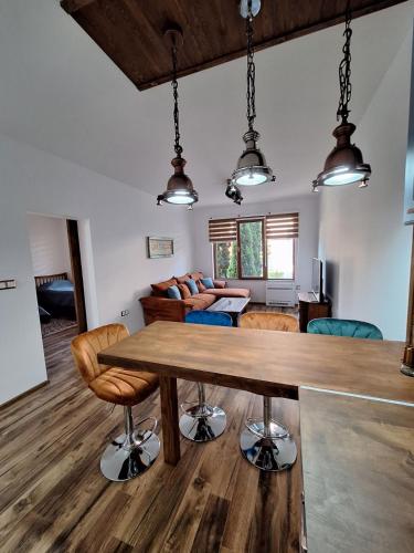 a kitchen and living room with a wooden table and chairs at Apartment Pirin in Bansko