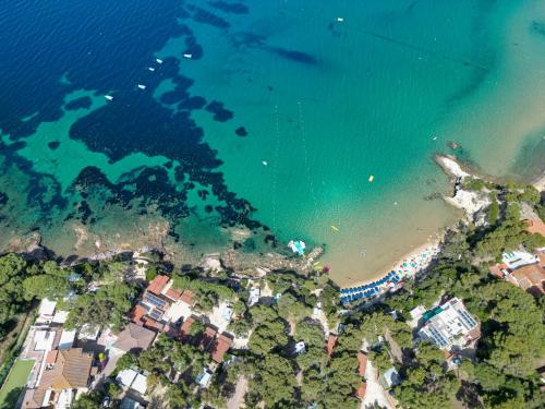 an aerial view of a beach and the ocean at Camping Village Le Calanchiole in Capoliveri