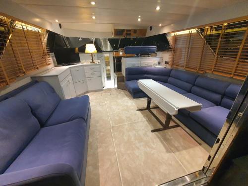 a living room with blue couches and a table at Yacht ZEN in Heraklio