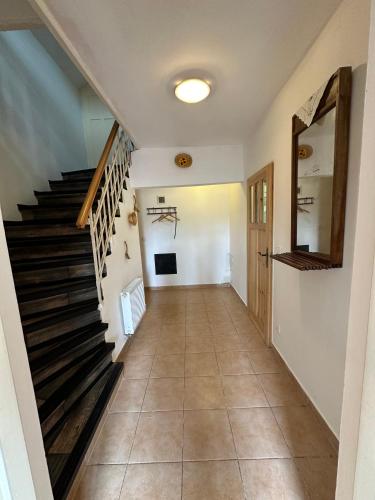 a hallway of a house with a staircase at Chalupa na soutoku in Lobendava