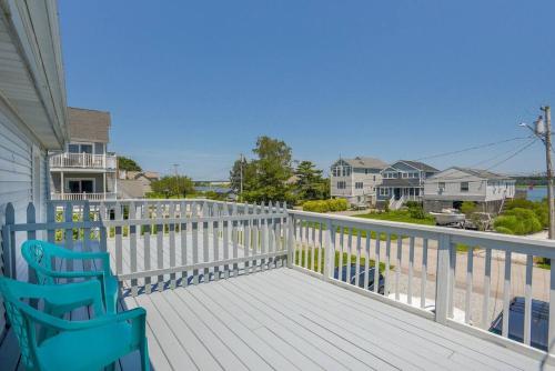 a deck with two blue chairs on a house at New cozy coastal retreat! in Groton