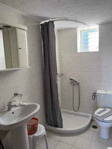a bathroom with a tub and a sink and a toilet at Zaga Apartments - Flats in Koroni