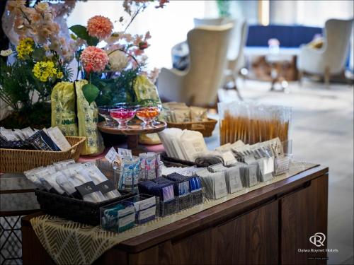 a table with a bunch of products on it at Daiwa Roynet Hotel Osaka Sakaisuji Honmachi PREMIER in Osaka