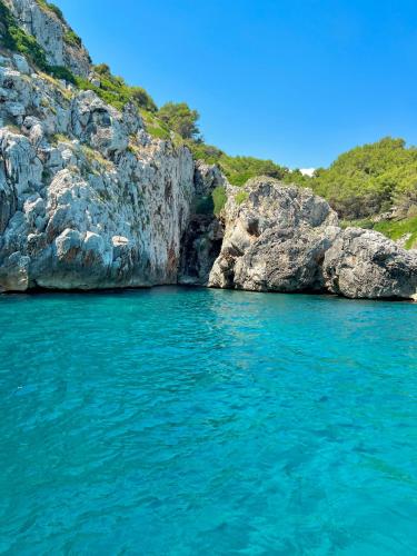 a large body of water next to a rocky cliff at La Casetta Casa Vacanze in Alessano