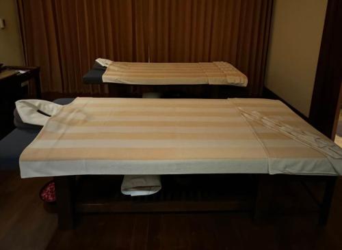 two beds in a hospital room with at Arthitaya Green Nature Hotel & Lakkhana Poolside Resort in Pattaya North