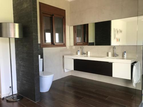a bathroom with a sink and a toilet in it at Villa Xauxa - Vida mediterránea in Gandía