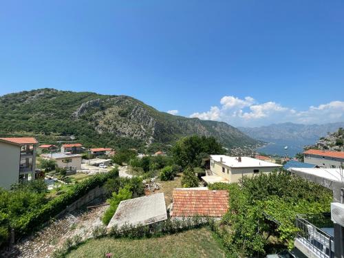 a view of a town with mountains in the background at Apartment Perović in Kotor