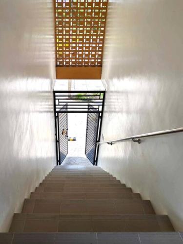 a stairway leading up to a door in a building at La Mirie Calumpit 2 in Balite