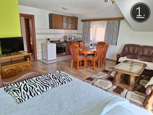 a living room with a table and a kitchen at Apartments Sokolović in Višegrad