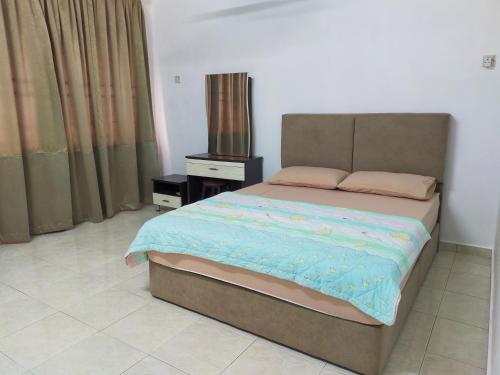 a bedroom with a bed and a nightstand and a bed sidx sidx at Malim Joyous Homestay - rent room only in Melaka