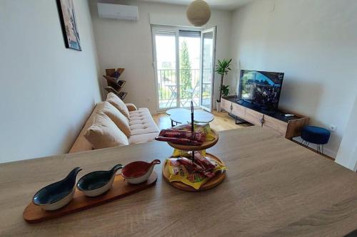 a living room with a table with shoes on it at Urban Escape Apartment in Pobrežje