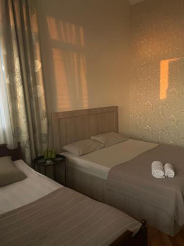 a bedroom with two beds with towels on them at Nits Guesthouse in Kvariat'i