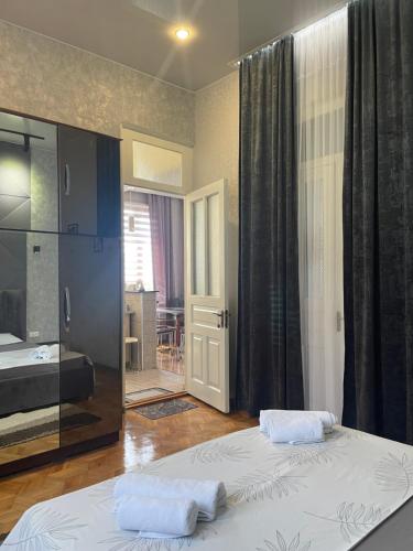 a bedroom with two beds and a sliding glass door at Nits Guesthouse in Kvariat'i