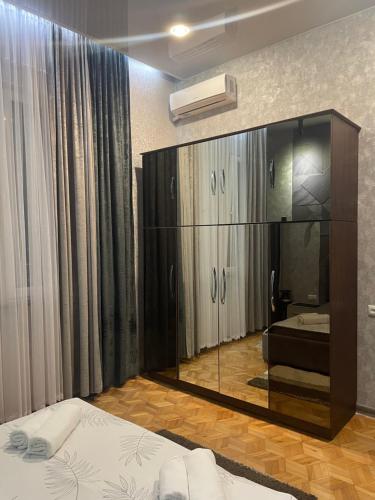 a bedroom with a bed and a large mirror at Nits Guesthouse in Kvariat'i
