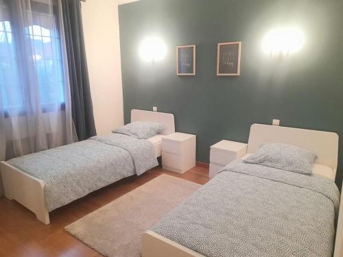 une chambre avec deux lits et une fenêtre dans l'établissement Charmante maison sur Auxerre, à Auxerre