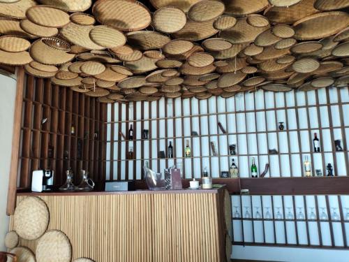 a bar with a bunch of bottles on the wall at La Spiaggia, tropical villa with private beach in Sainte Marie