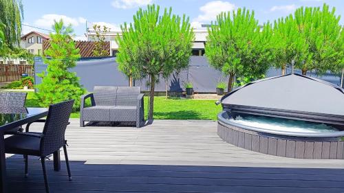 a patio with a fire pit and a table and chairs at airzeb Uno - A3 Highway at Borș2 in Biharia
