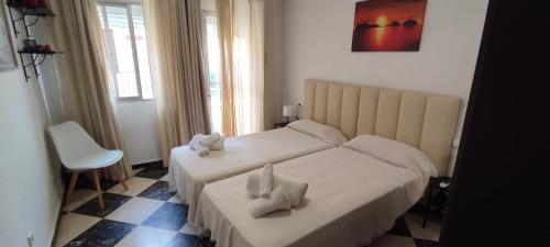 a hotel room with two beds with towels on them at Precioso apartamento con vistas al Mar. in La Cala de Mijas