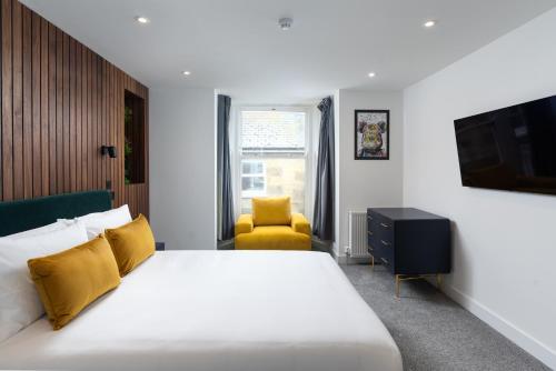 a bedroom with a bed and a tv and a chair at Room 2 Hotel style Double bedroom in Marazion in Marazion