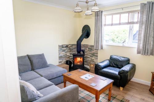 a living room with a couch and a wood stove at Holmside Hideaway in Newcastle upon Tyne
