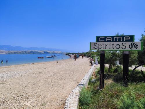 a sign on a beach next to a body of water at Izzi Mobile Home - Terra Park SpiritoS in Kolan