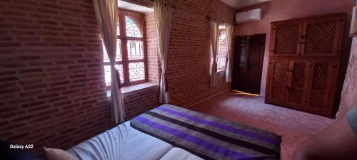 Postel nebo postele na pokoji v ubytování Riad maison Bounouar