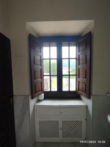 a bathroom with a window and a window seat with a window at Chavarri Etxea, casa indiana XBI00149 in Biáñez