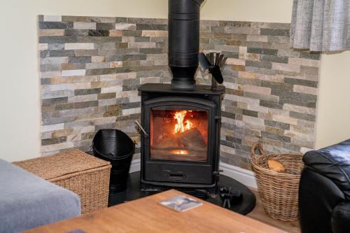 a stove in a living room with a fireplace at Holmside Hideaway in Newcastle upon Tyne