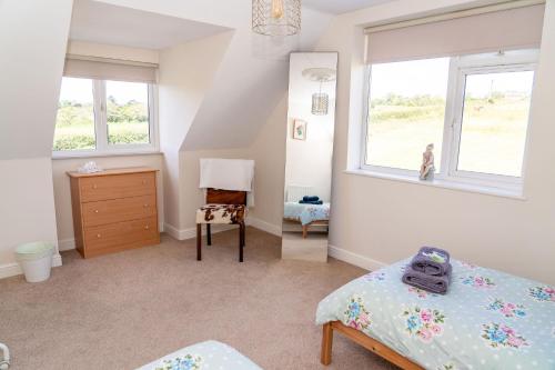 a bedroom with two beds and a dresser and a window at Holmside Hideaway in Newcastle upon Tyne