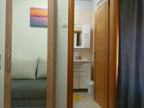 a door leading to a bathroom with a sink at Vacation Home Keskic in Velika Gata