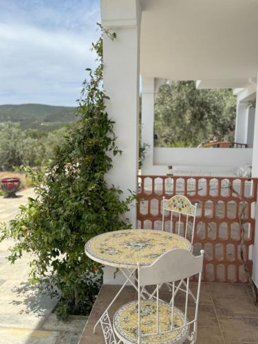 a table and chairs on a porch with a view at Villa Wishflower in Lefokastro