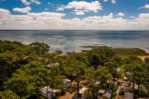 an aerial view of a lake with trees and houses at Charmant Mobile Home Cap-Ferret in Lège-Cap-Ferret