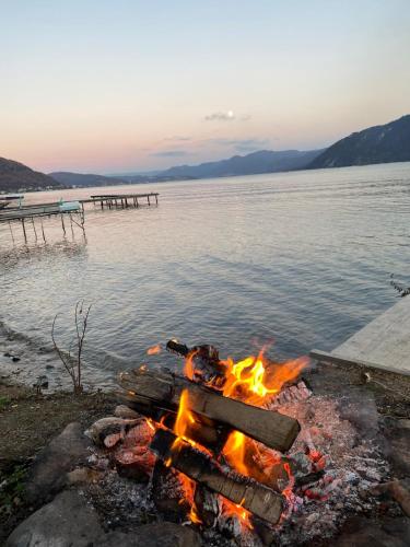 a bonfire on the beach next to a body of water at Nature Nook in Eşelniţa