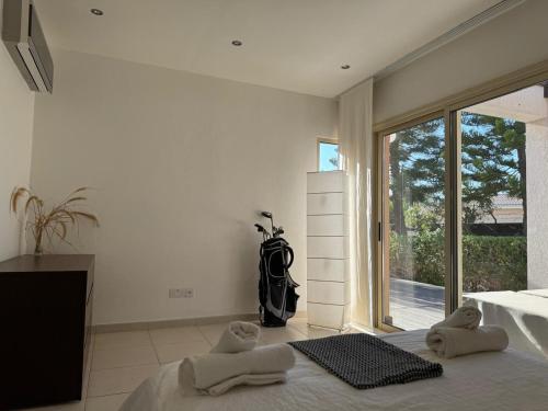 a bedroom with a bed and a large window at Best Latchi Thalassa Villa in Lachi