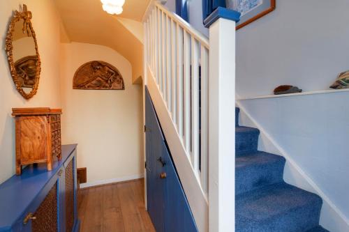 a staircase with blue and white stairs in a house at Rosehip Cottage Period home, Bingham, Nottingham in Bingham