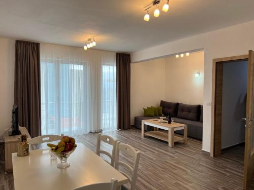 a living room with a couch and a table and chairs at N apartments in Utjeha