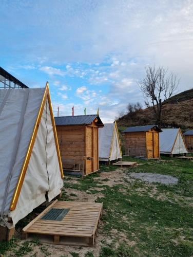 a group of tents in a field with grass at Driftters in Chakrāta