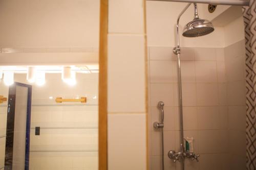 a bathroom with a shower and a mirror at Marmotte Mountain Manor in Chamonix-Mont-Blanc