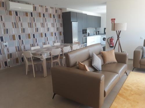 a living room with a couch and a table at Casa Ambiente Verde in Caldas da Rainha