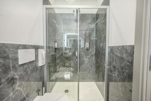 a bathroom with a shower with a toilet and a sink at Affittacamere I Tesori di Modena in Modena