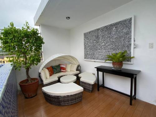 a living room with a couch and a table at Marketpoint Hotel in Mogpog