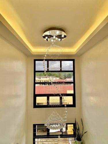 a chandelier in a room with a window at Marketpoint Hotel in Mogpog