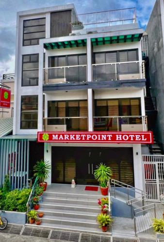 a building with a marvellous hotel with a sign on it at Marketpoint Hotel in Mogpog