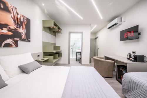 a bedroom with a white bed and a desk at Affittacamere I Tesori di Modena in Modena