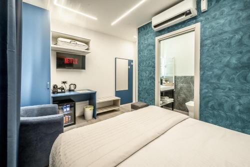 a bedroom with a white bed and a blue wall at Affittacamere I Tesori di Modena in Modena