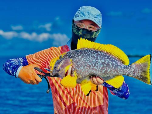 a man in a mask holding a fish at Mikado Break Inn in Veymandoo