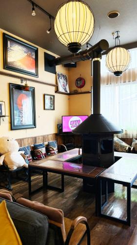 a living room with a wood stove in a room at Yufuin Tabinokura in Yufuin