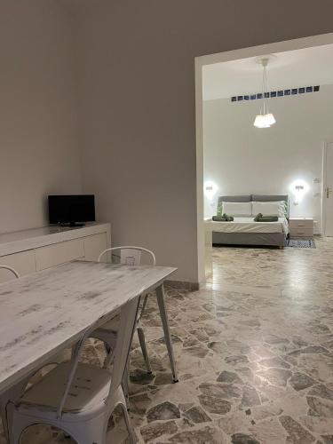 a living room with a table and chairs and a couch at VENTINOVE Apartments in Otranto